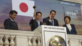With the help of John Tuttle, vice chairman of the New York Stock Exchange, second right, Prime Minister of Japan Fumio Kishida, second left, uses a gavel while ringing the bell at the NYSE on Thursday, Sept. 22, 2022 in New York. (AP Photo/Andres Kudacki)