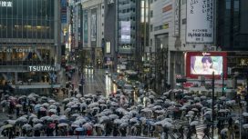 Umbrellas fill the famed Shibuya scramble crossing as people walk across the intersection in rain Monday, April 4, 2022, in Tokyo. (AP Photo/Kiichiro Sato)