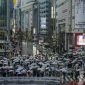 Umbrellas fill the famed Shibuya scramble crossing as people walk across the intersection in rain Monday, April 4, 2022, in Tokyo. (AP Photo/Kiichiro Sato)